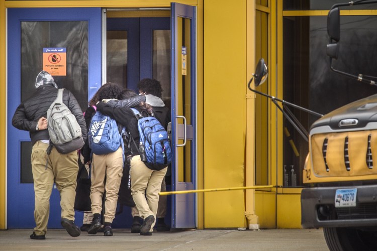 Students at Sport and Medical Sciences Academy return to school, Jan. 19, 2022 in Hartford, Conn. The school has been closed since last week after a student died from a fentanyl overdose. The death of the seventh grader has renewed calls for schools to carry the opioid antidote naloxone. The 13-year-old student in Hartford died after falling ill in school two days earlier. 