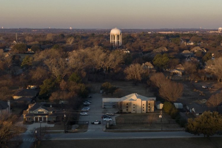 Police vehicles are parked in front of Congregation Beth Israel synagogue in Colleyville, Texas, on Sunday.