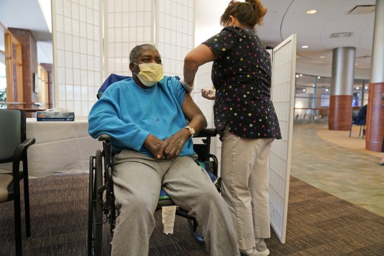 Edward Williams, 62, a resident at the Hebrew Home at Riverdale, receives a COVID-19 booster shot Sept. 27, in New York.