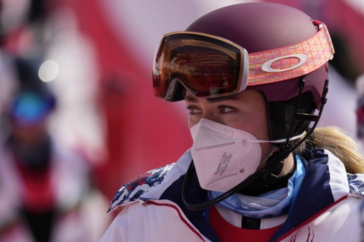 Mikaela Shiffrin leaves the finish area after skiing out in the first run of the women's slalom at the 2022 Winter Olympics on Wednesday.