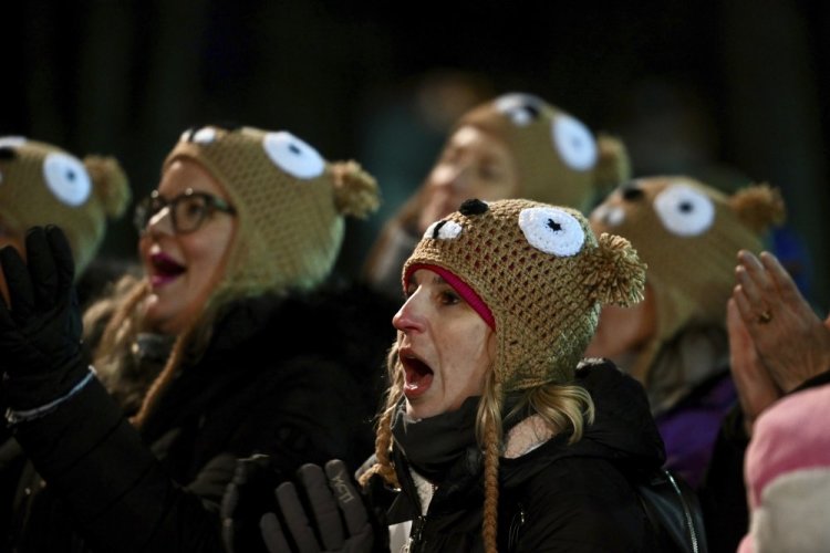 Ashley Johnson of Dallas watches entertainment while waiting for Punxsutawney Phil, the weather prognosticating groundhog, to come out and make his prediction during the 136th celebration of Groundhog Day on Gobbler's Knob in Punxsutawney, Pa.