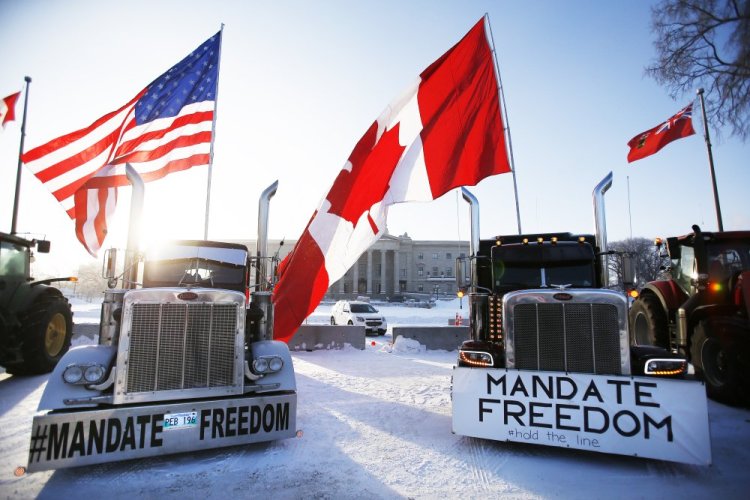 Demonstrators rally against provincial and federal COVID-19 vaccine mandates and in support of Ottawa protestors Friday outside the Manitoba Legislature in Winnipeg.