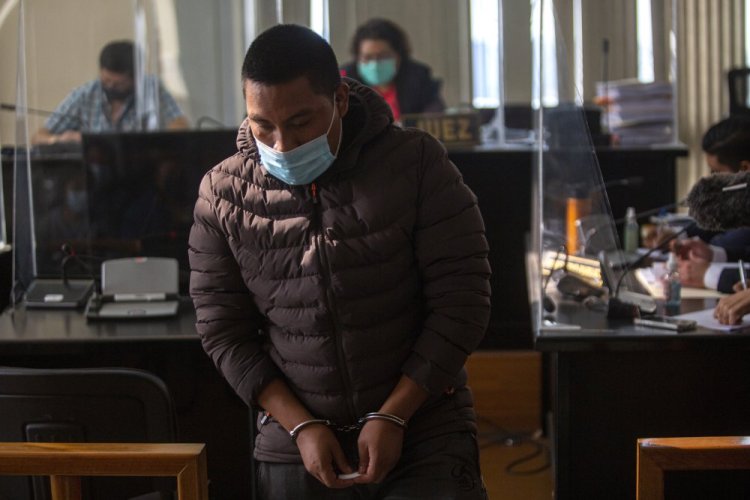 Juan Miranda, who is allegedly part of a migrant smuggling network, returns to his place after questioning in the courts of justice in Guatemala City on Feb. 4.