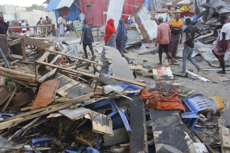People look at destroyed shops at Mogadishu's Lido beach in Somalia on Saturday after a bomb blast hit a popular seaside restaurant.