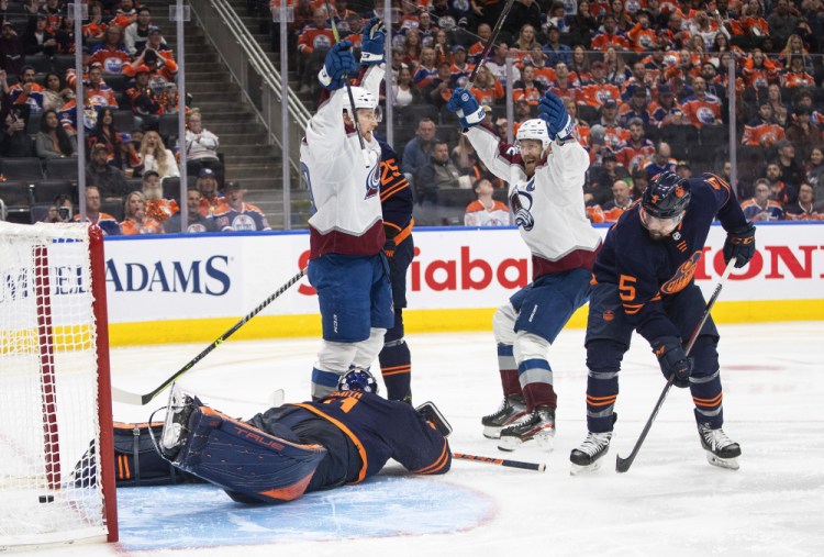 Colorado's Nathan MacKinnon (29) and Gabriel Landeskog (92) celebrate a goal past Edmonton Oilers goalie Mike Smith. 