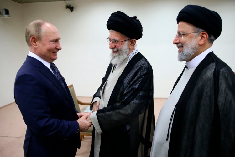 In this picture released by the official website of the office of the Iranian Supreme Leader Ayatollah Ali Khamenei, center, and Russian President Vladimir Putin, left, greet each other as Iranian President Ebrahim Raisi stands at right, during their meeting in Tehran, Iran, on Tuesday. 