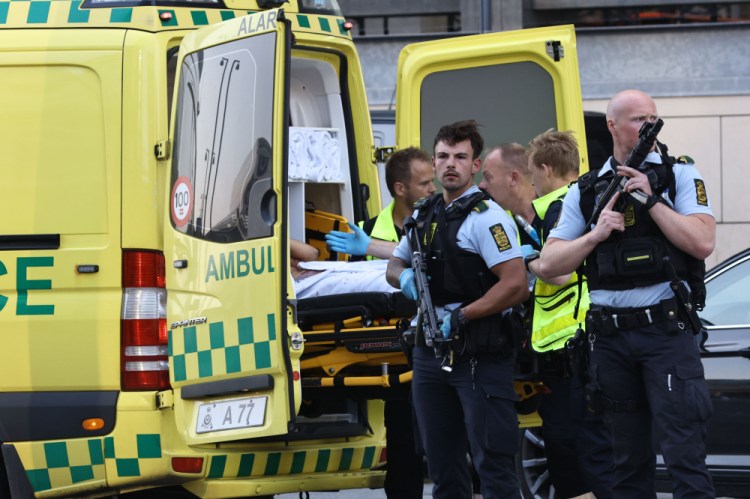 An ambulance and armed police outside the Field's shopping center, in Orestad, Copenhagen, Denmark, Sunday after reports of shots fired. 