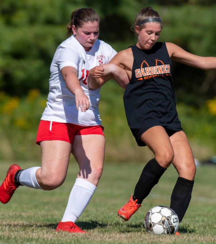 Wiscasset defender Carolyn Potter, left, looks to take the ball away from Gardiner's Abby Cooley during a play day preseason tournament August 20 in Richmond. Due to low numbers, the Wiscasset/Boothbay girls and boys soccer teams had to pull out of varsity competition this fall, creating last minute scheduling issues for athletic directors in the Mountain Valley Conference.