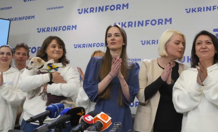 Center for Civil Liberties officials Oleksandra Matviychuk, center, and executive director Oleksandra Romantsova, center left, exit a news conference in Kyiv, Ukraine, on Saturday. The organization was one of three entities sharing the Nobel Peace Prize on Friday. Efrem Lukatsky/Associated Press
