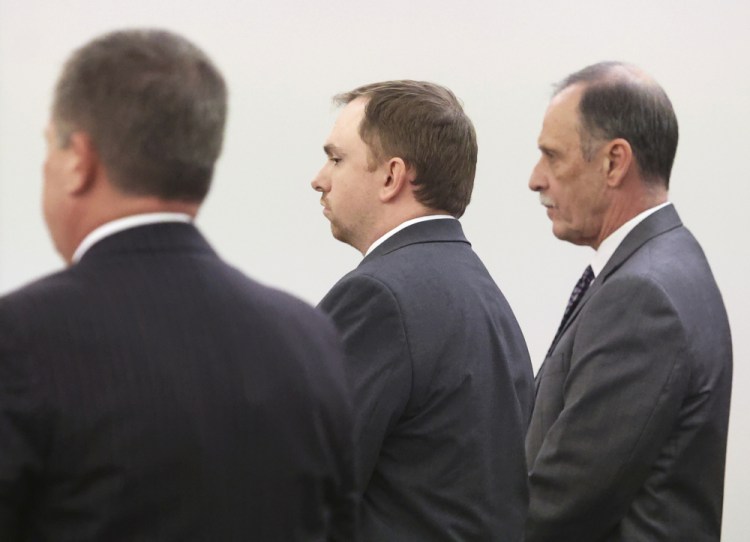 Aaron Dean, center, stands with his defense team as Judge George Gallagher reads his sentence on Tuesday at the Tim Curry Criminal Justice Center in Fort Worth, Texas. 