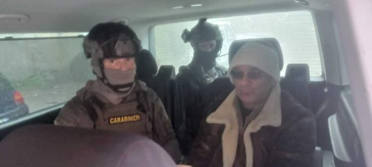 Top Mafia boss Matteo Messina Denaro, right,  with Italian Carabinieri officers soon after his arrest Monday at a private clinic in Palermo, Sicily. 