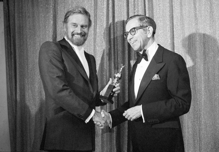 Walter Mirisch, right, and Charlton Heston celebrate at the 34th annual Golden Globe awards, presented by the Hollywood Foreign Press Association at the Beverly Hilton in Los Angeles, on Jan. 29, 1977. (AP Photo, File)
