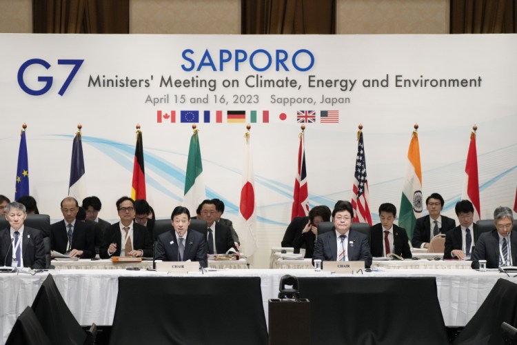 Japan's Economy Minister Yasutoshi Nishimura, center left, with Environment Minister Akihiro Nishimura, center right, speaks at the beginning of a plenary session in the G-7 ministers' meeting on climate, energy and environment as they co-chair the meeting in Sapporo, northern Japan on Saturday. Hiro Komae/Associated Press