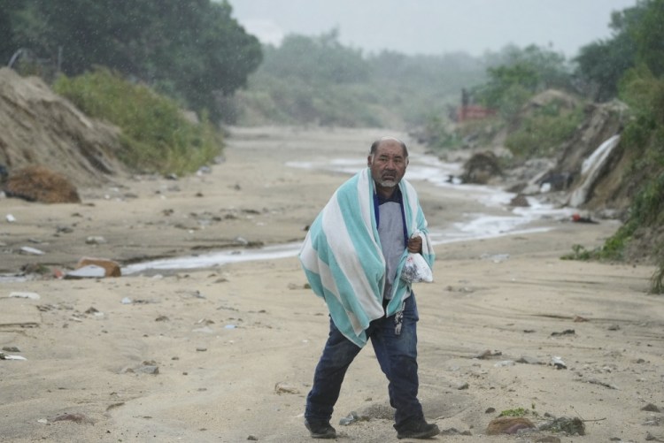 A man walks on the mud caused by Hurricane Norma in San Jose del Cabo, Mexico, on Saturday.
Fernando Llano/Associated Press